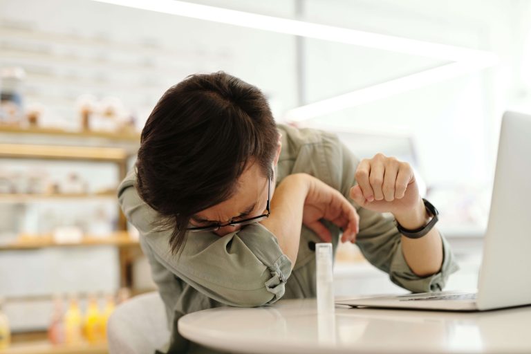 man sneezing allergies indoors carpet air quality scaled